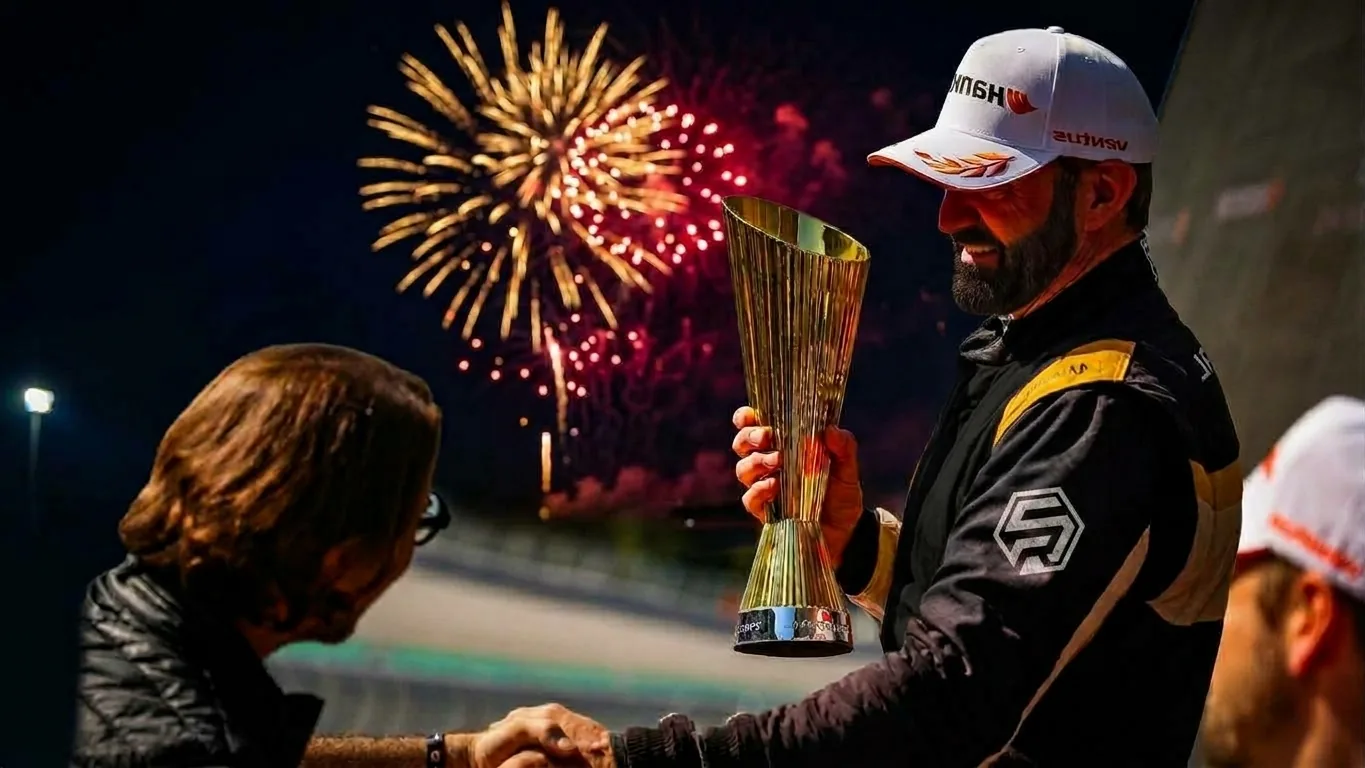 Radical Cup champion shaking hands while holding a trophy beneath fireworks